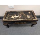 An oriental lacquered hardstone inlaid coffee table