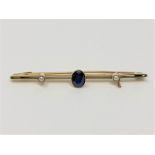 A 15ct gold brooch set with a sapphire, 2.9g.