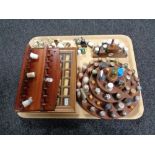 A tray of three wooden thimble display stands,