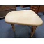 A contemporary light wood occasional table