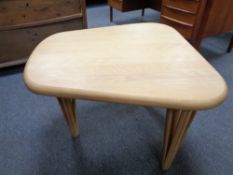 A contemporary light wood occasional table