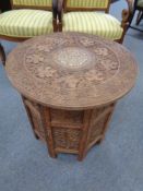 A heavily carved anglo Indian octagonal occasional table with bone inlay