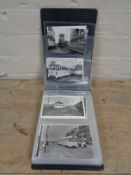 An album of antique black and white postcards depicting Blackpool and trolley busses