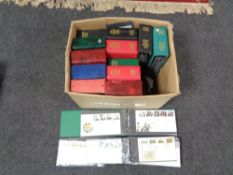 A box of fourteen albums of first day covers