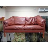 A contemporary Danish red leather two seater settee