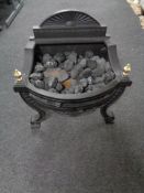 A coal effect electric fire in cast iron grate