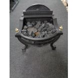 A coal effect electric fire in cast iron grate