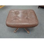 A mid century continental buttoned leather footstool