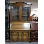 An oak leaded glass fall fronted bureau bookcase