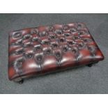 A Chesterfield red button leather oversized footstool