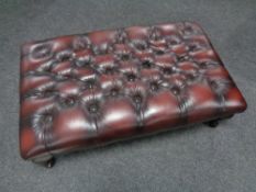 A Chesterfield red button leather oversized footstool