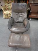A mid century Danish brown leather swivel relaxer chair with footstool on chrome suppor