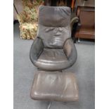 A mid century Danish brown leather swivel relaxer chair with footstool on chrome suppor