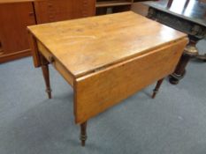 A nineteenth century pine drop leaf kitchen table fitted a drawer
