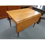 A nineteenth century pine drop leaf kitchen table fitted a drawer