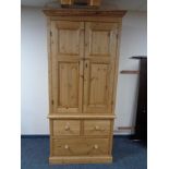A pine double door wardrobe fitted with three drawers beneath, width 100 cm, depth 60 cm,
