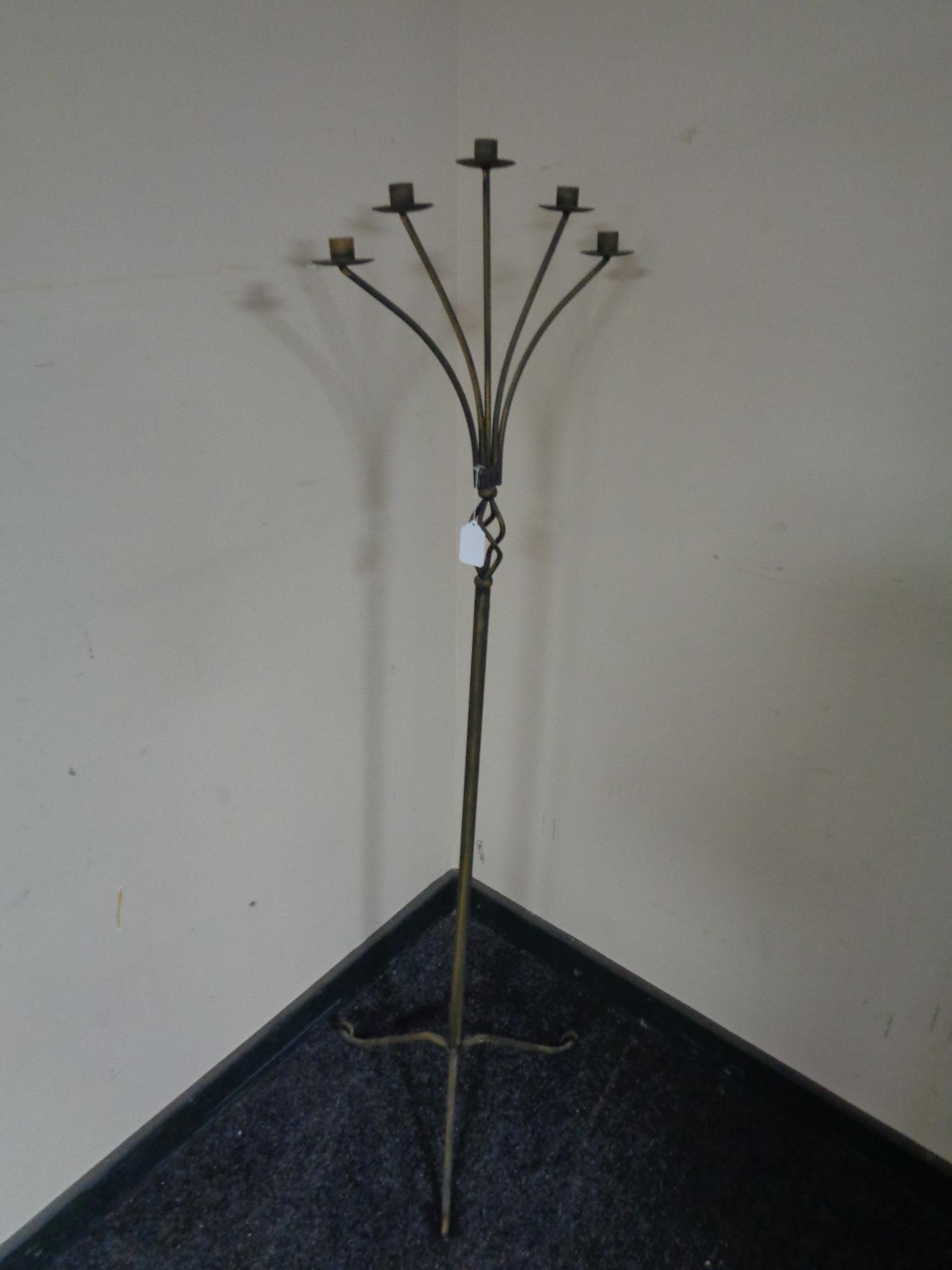 A wrought metal five way floor standing candle holder