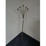 A wrought metal five way floor standing candle holder