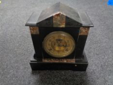 A Victorian black slate mantel clock with brass dial