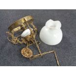 A Continental gilt metal hanging oil lamp with opaque glass resevoir (converted),