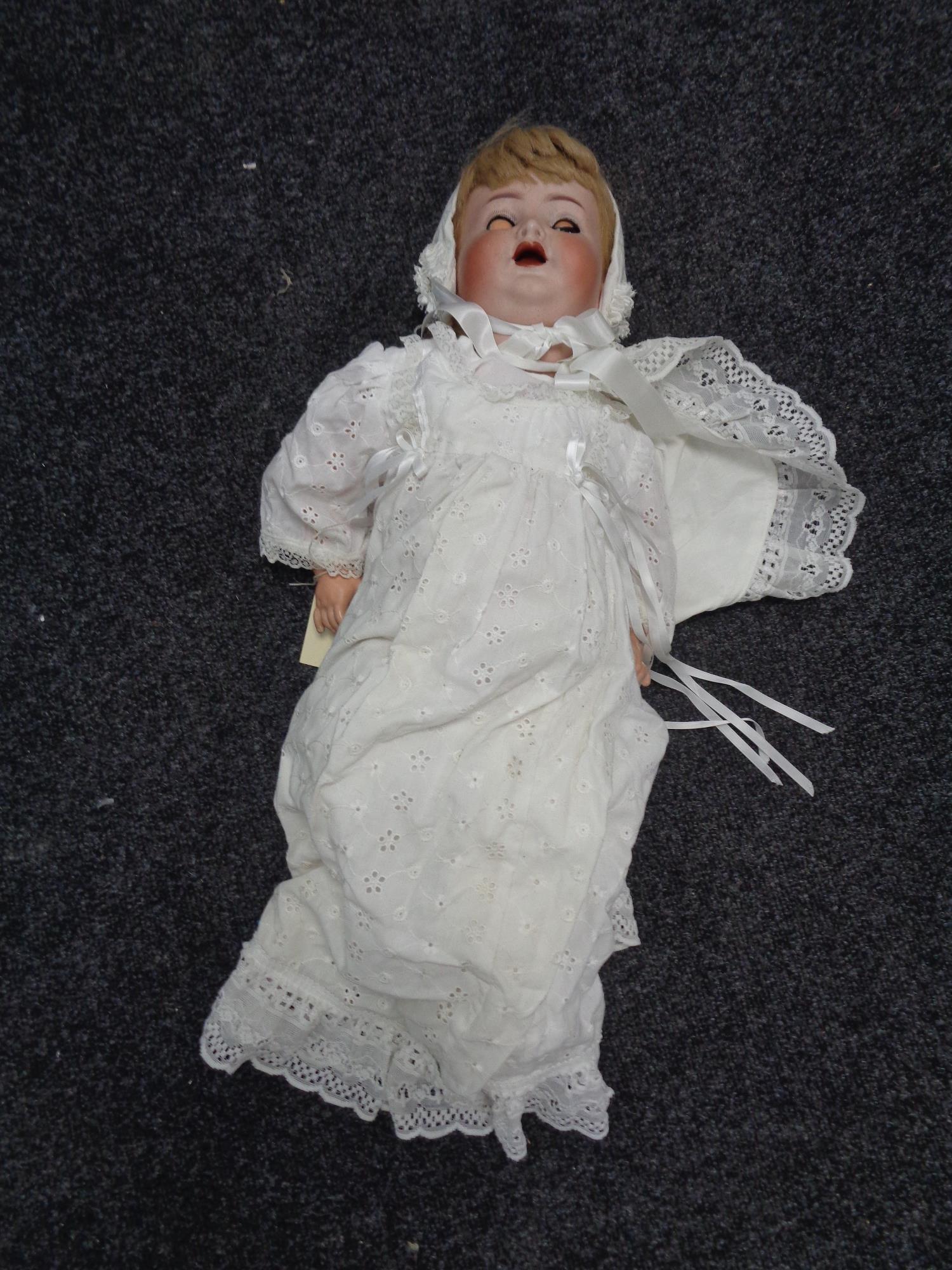 A Simon and Halbig porcelain headed doll with noise maker