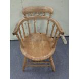 A nineteenth century beech spindle backed armchair (Af)