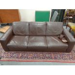 A contemporary brown leather three seater settee