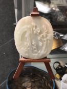 A carved jade roundel on later stand