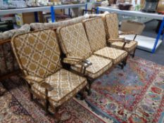 A three piece wood framed cottage lounge suite in gold and cream fabric