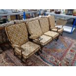 A three piece wood framed cottage lounge suite in gold and cream fabric