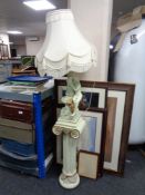 A figural table lamp with tassel shade on pedestal,