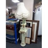 A figural table lamp with tassel shade on pedestal,