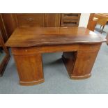 An early twentieth century continental mahogany twin pedestal writing desk