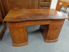 An early twentieth century continental mahogany twin pedestal writing desk