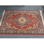 A machined Persian designed rug on red ground 206 cm x 131 cm
