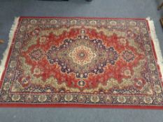 A machined Persian designed rug on red ground 206 cm x 131 cm
