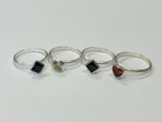 Four silver gem set rings