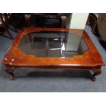 A large contemporary glass topped coffee table