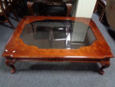 A large contemporary glass topped coffee table