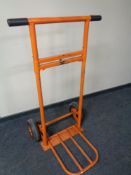 A heavy duty sack barrow with adjustable foot plate and spring loaded axle