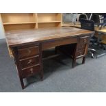 An Edwardian oak twin pedestal desk fitted seven drawers