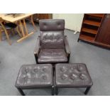 A mid century Danish brown studded leather armchair together with two similar footstools