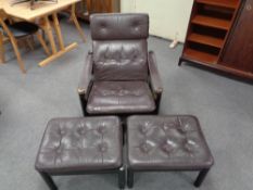 A mid century Danish brown studded leather armchair together with two similar footstools