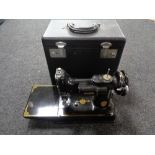 A small Singer hand sewing machine in carry case