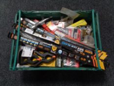 A crate of new tools, bow saw blades, brick hammers,