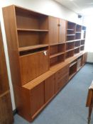 A large Danish teak display unit fitted with cupboards and shelves, width 430 cm x 190 cm height,