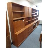 A large Danish teak display unit fitted with cupboards and shelves, width 430 cm x 190 cm height,