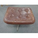 A mid century continental buttoned leather footstool on chrome support