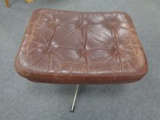 A mid century continental buttoned leather footstool on chrome support