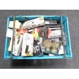 A crate of tools, drill bits, tape measures,